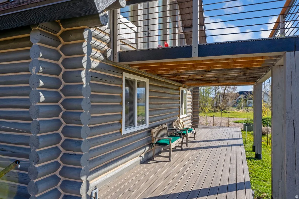 Expansive ground-level deck featuring composite decking and an overhead wood-finish ceiling