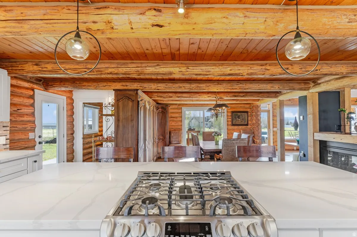 Modern gas range cooktop on a white stone-finish countertop with a tile backsplash