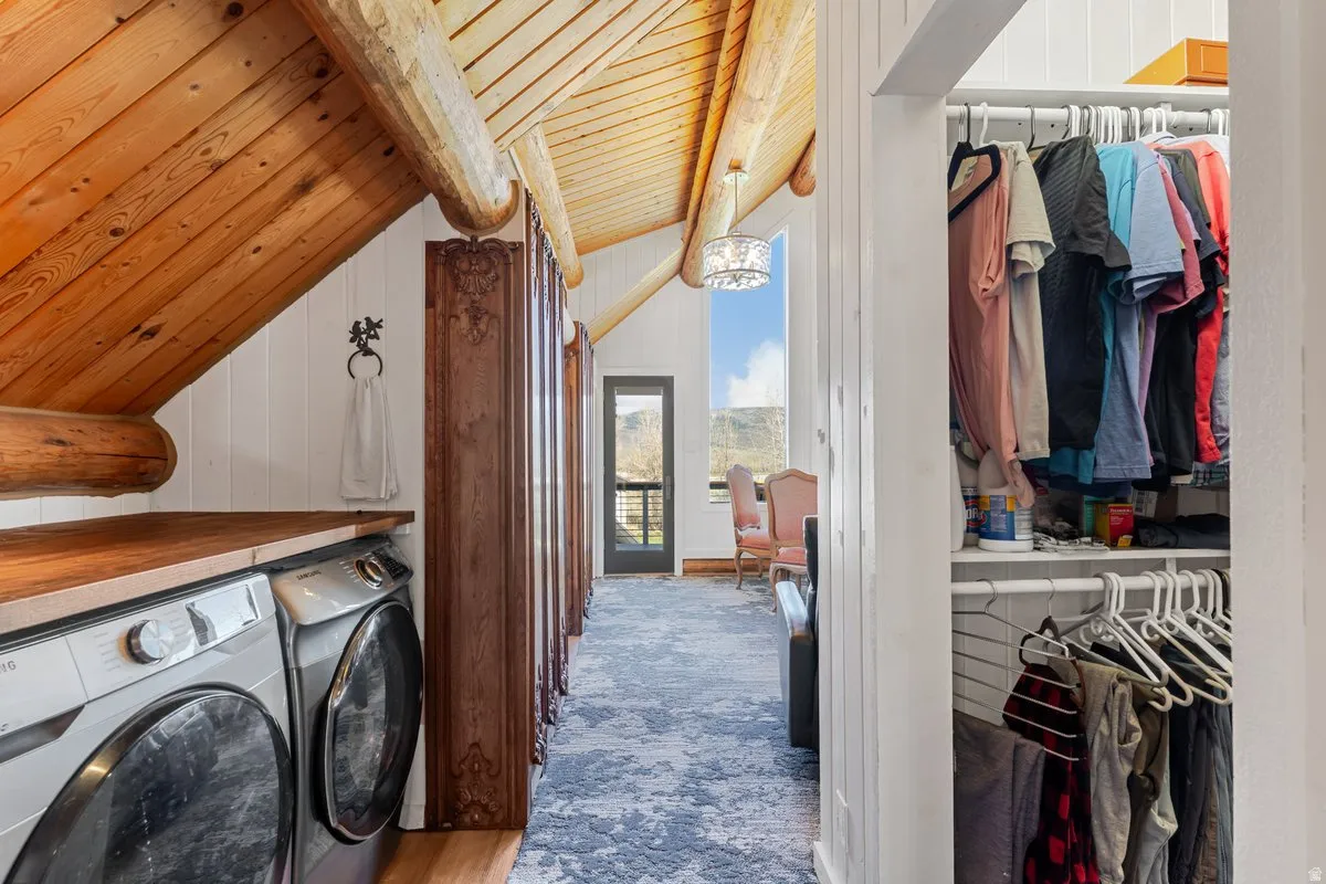 Laundry area with wood-finish countertop and vaulted wood-paneled ceiling with exposed beams