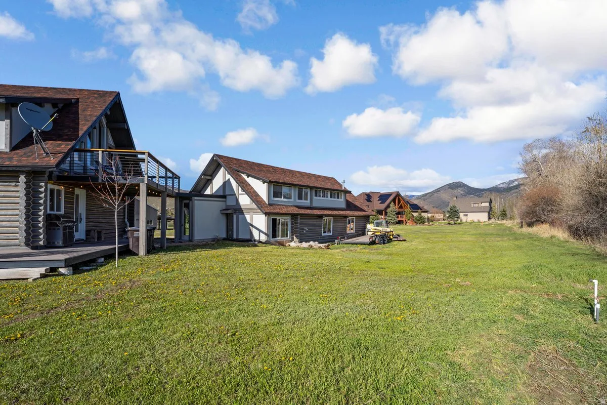 Expansive green lawn with mountain backdrop