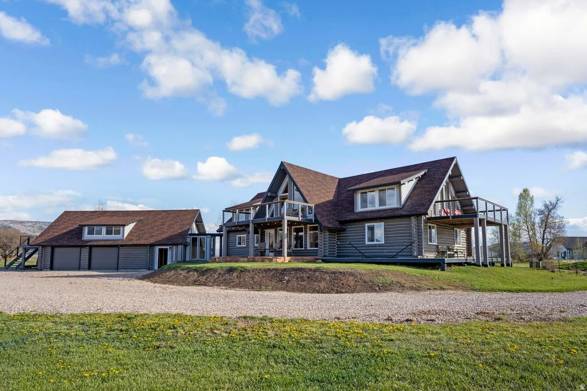 Log cabin style residence featuring a multi-level design and multiple outdoor balconies