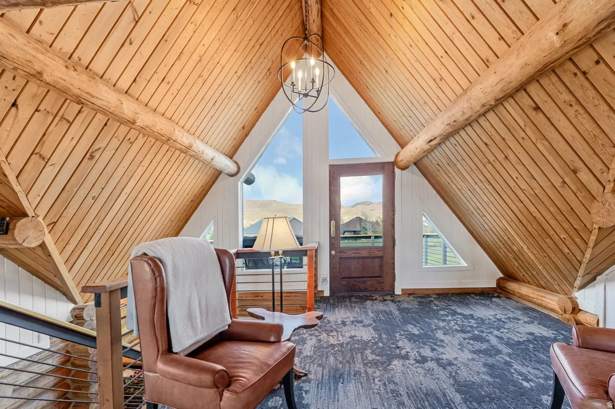Vaulted wood-paneled ceiling with exposed log beams