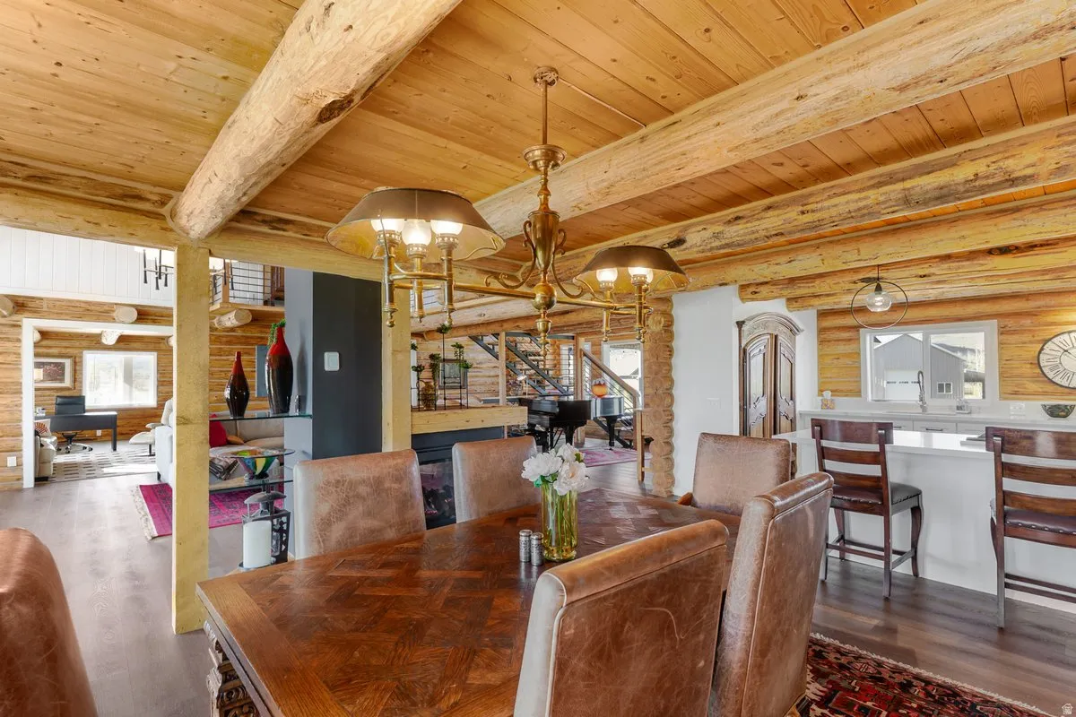 Dining area featuring an ornate chandelier over a large wood-finish table