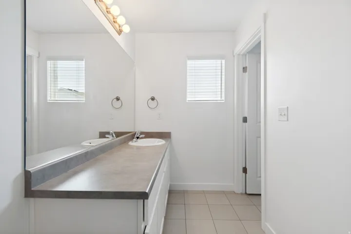 Double vanity with integrated sinks and a neutral-toned countertop