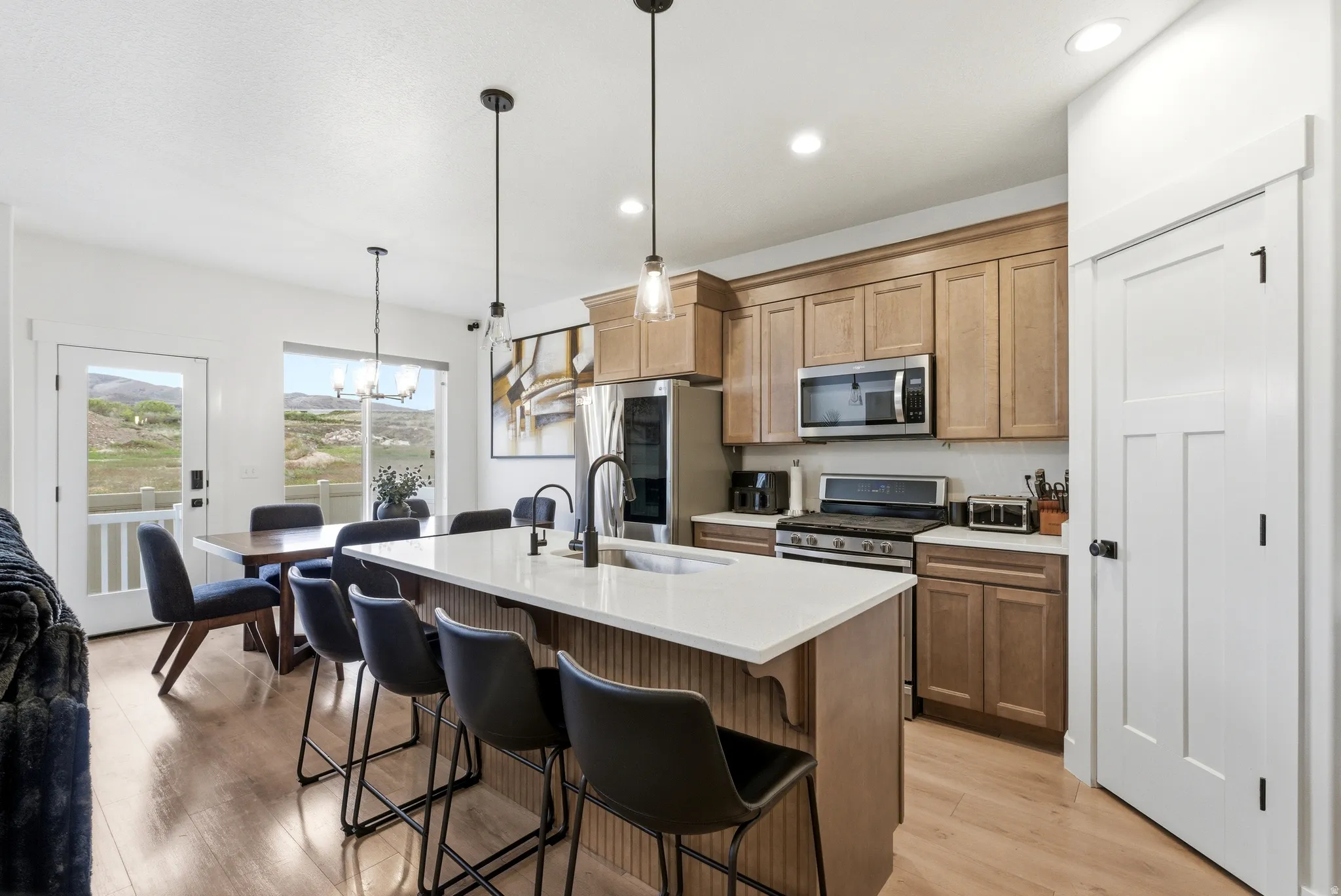 Open-concept kitchen and dining area featuring a central island with countertop seating