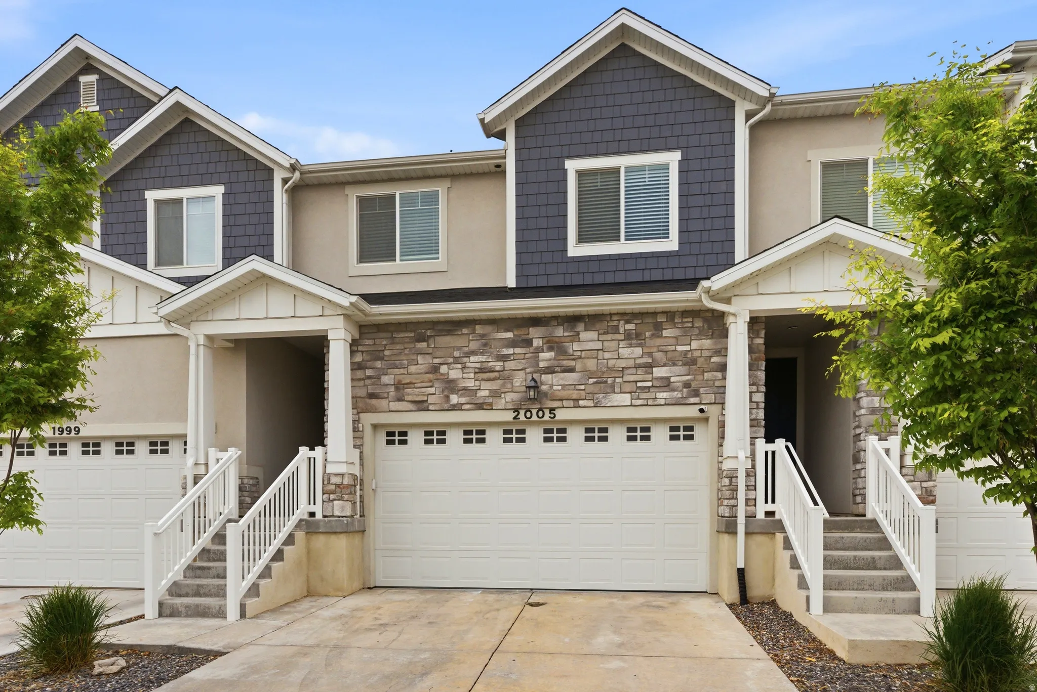 Stone veneer facade with shaker-style siding accents