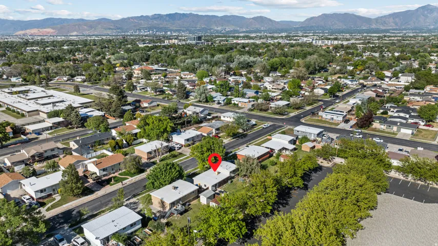 Aerial perspective showcasing a residential neighborhood with a prominent mountain backdrop