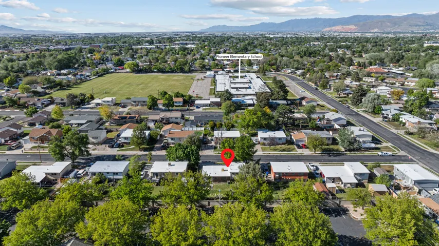 Aerial view showcasing a residential neighborhood with a variety of single-story homes