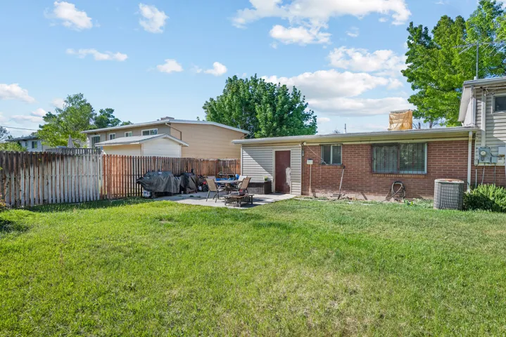 Expansive grass lawn with a concrete patio