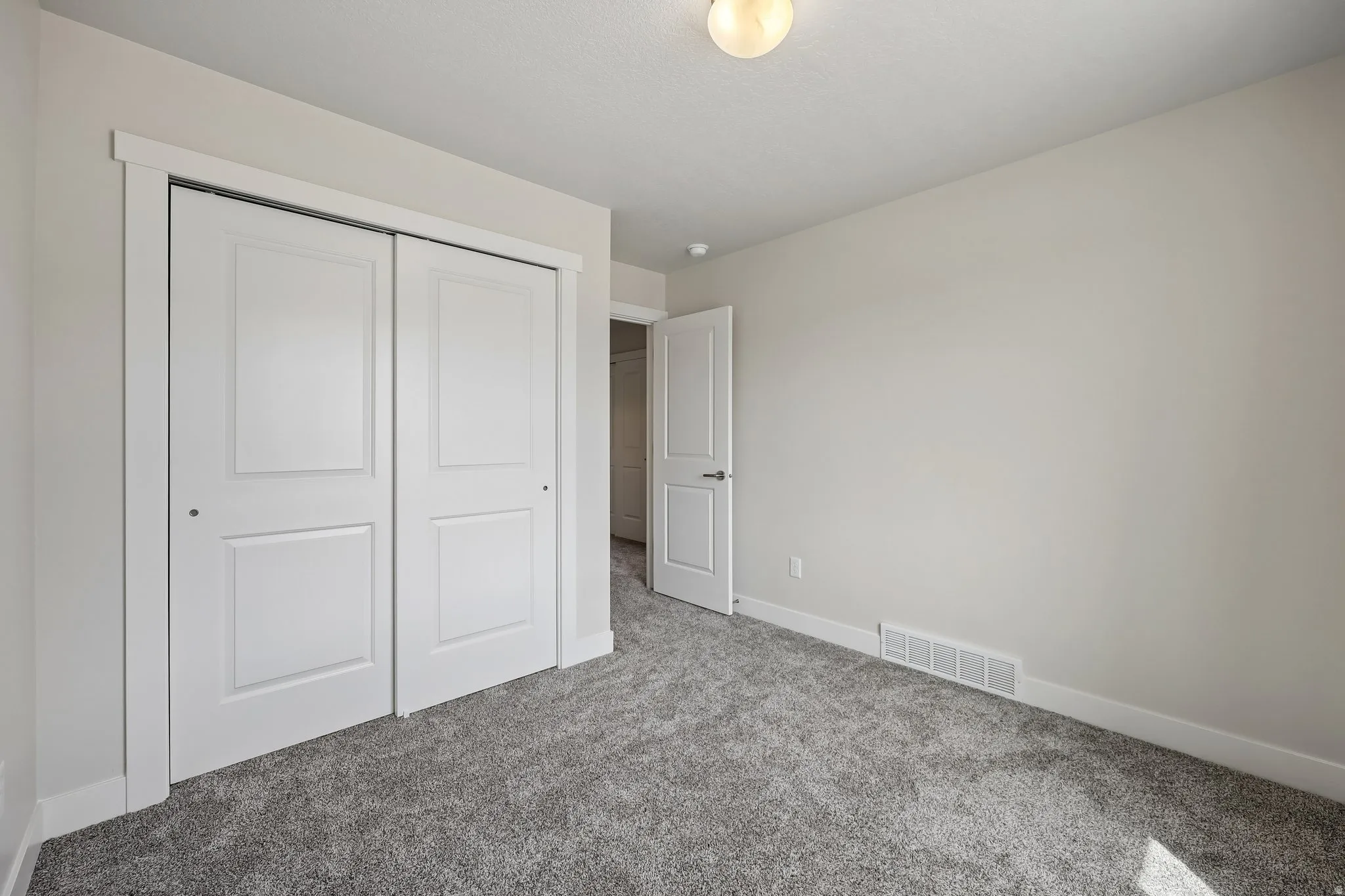 Unfurnished bedroom with carpet and a closet