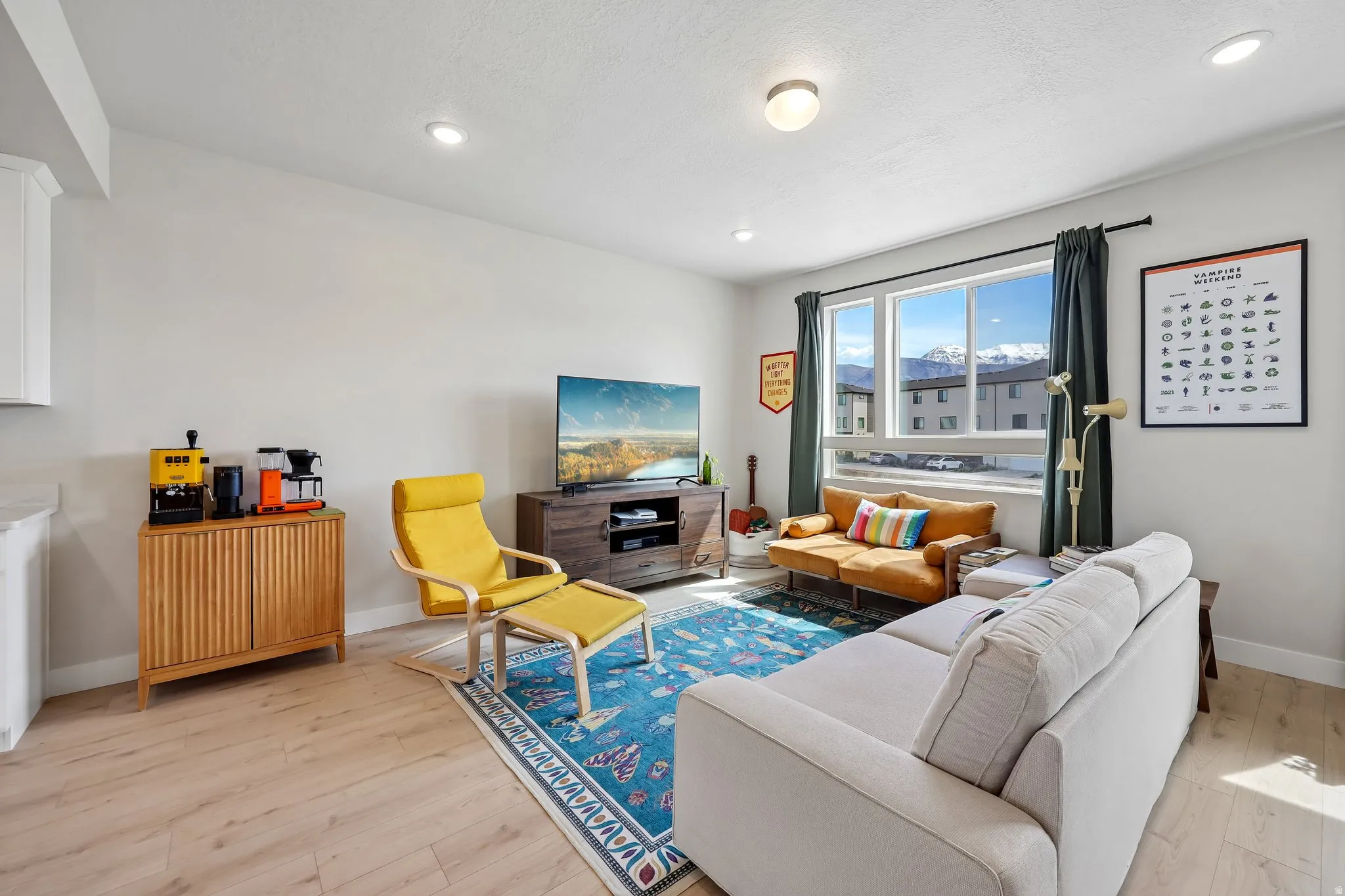 Living area featuring light wood-style floors and recessed lighting