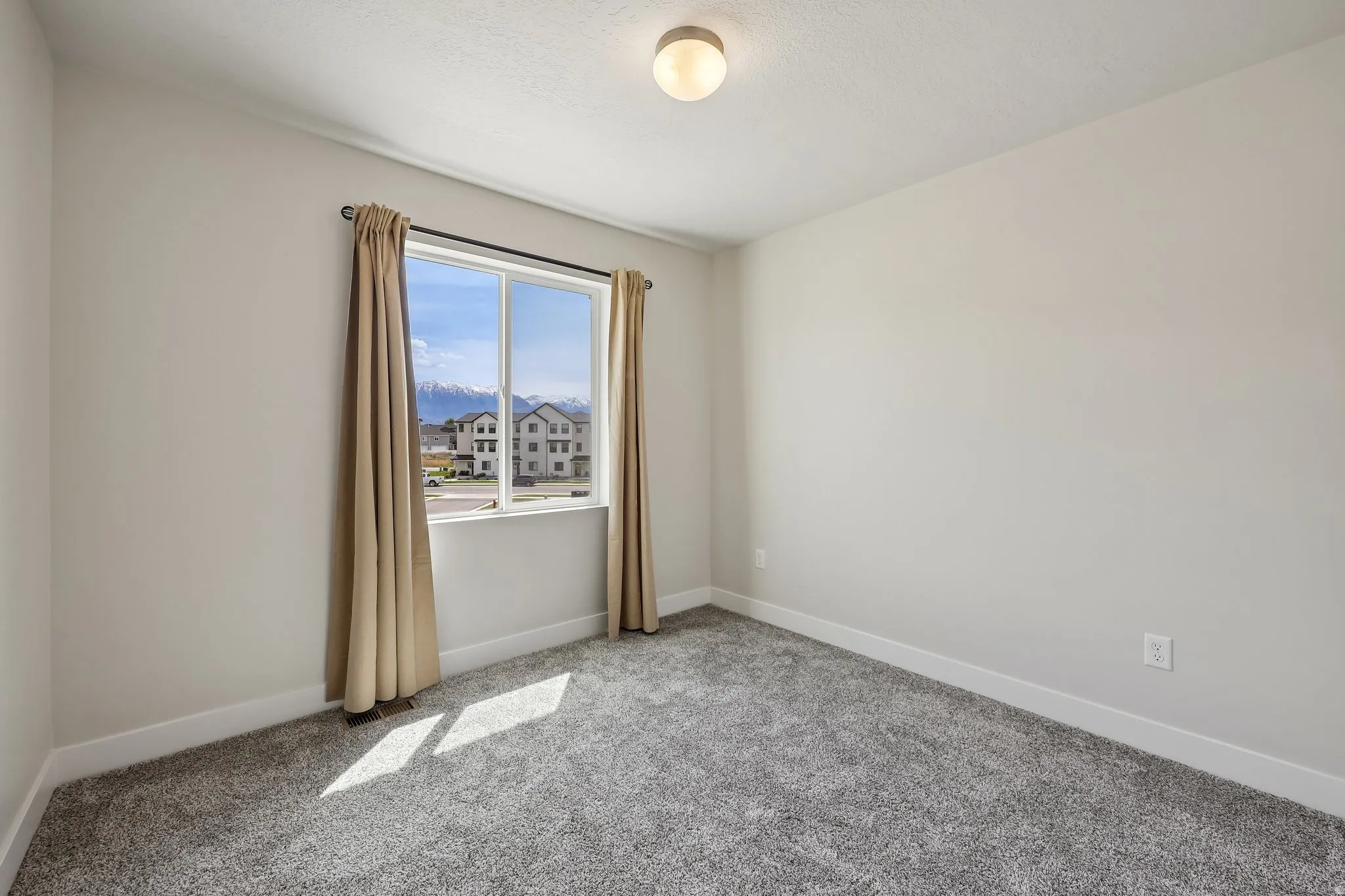 Spare room with light carpet and a mountain view