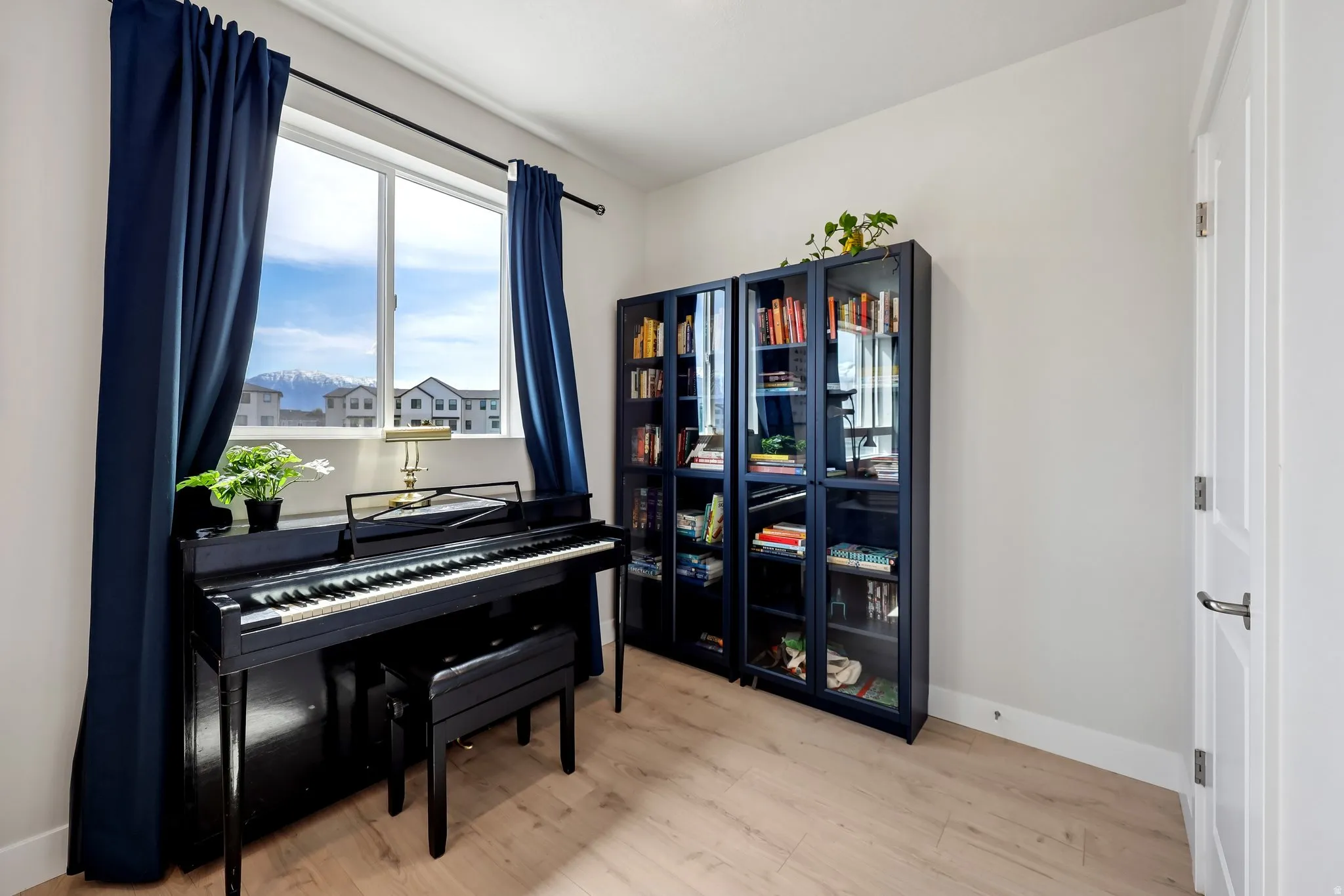Living area featuring baseboards and light wood finished floors