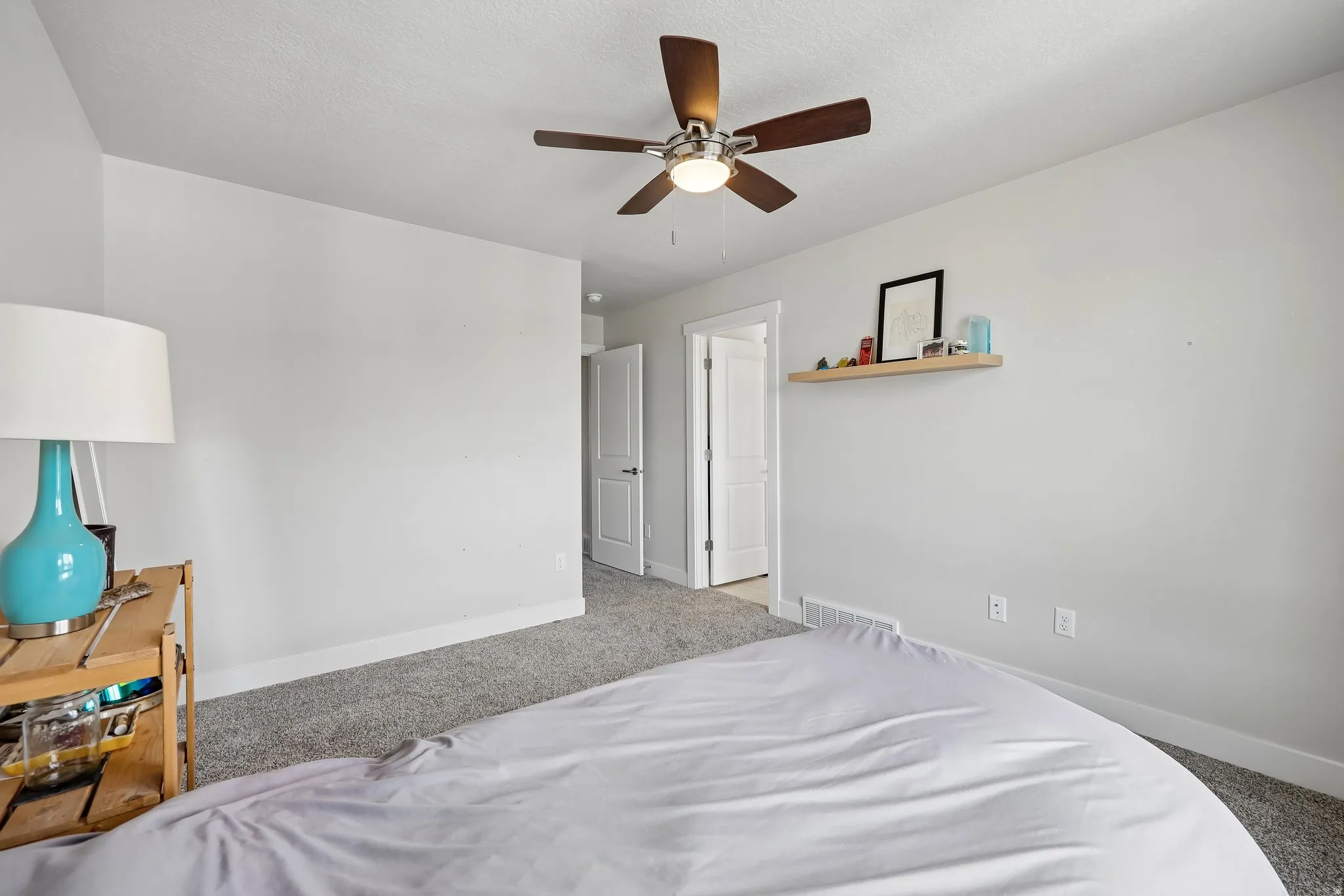 Bedroom featuring light colored carpet and a ceiling fan