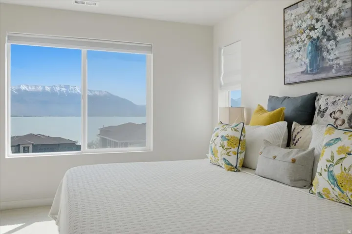 Expansive window framing a lake and mountain backdrop