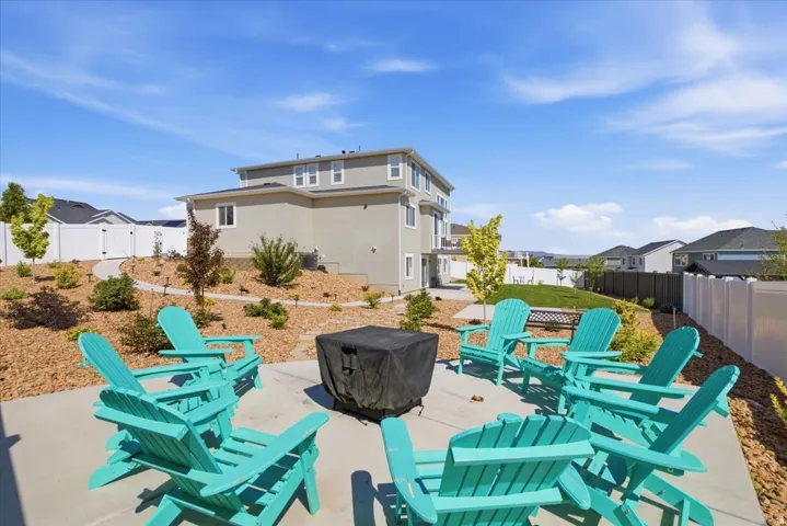 Expansive backyard patio featuring a concrete surface