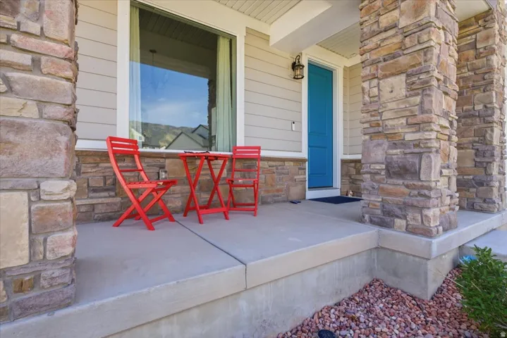 Stone veneer columns framing a front entry with a bright blue door
