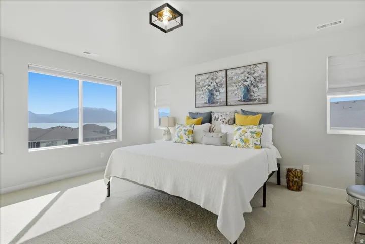 Expansive window offering distant water and mountain scenery