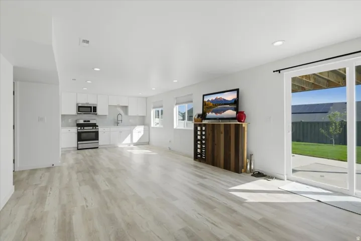 Open-concept living space with light wood-finish flooring