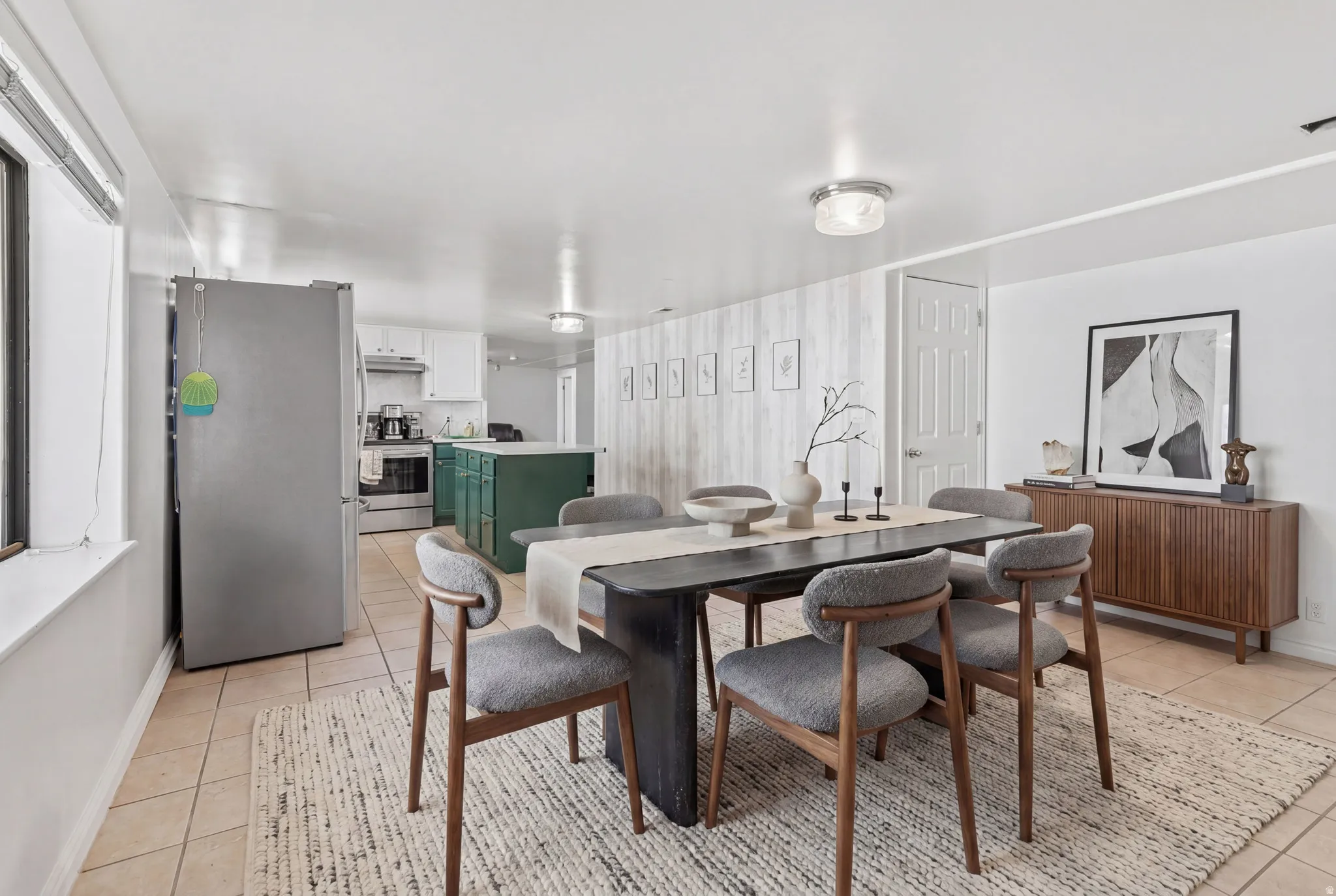 Open-concept kitchen and dining area featuring tile flooring