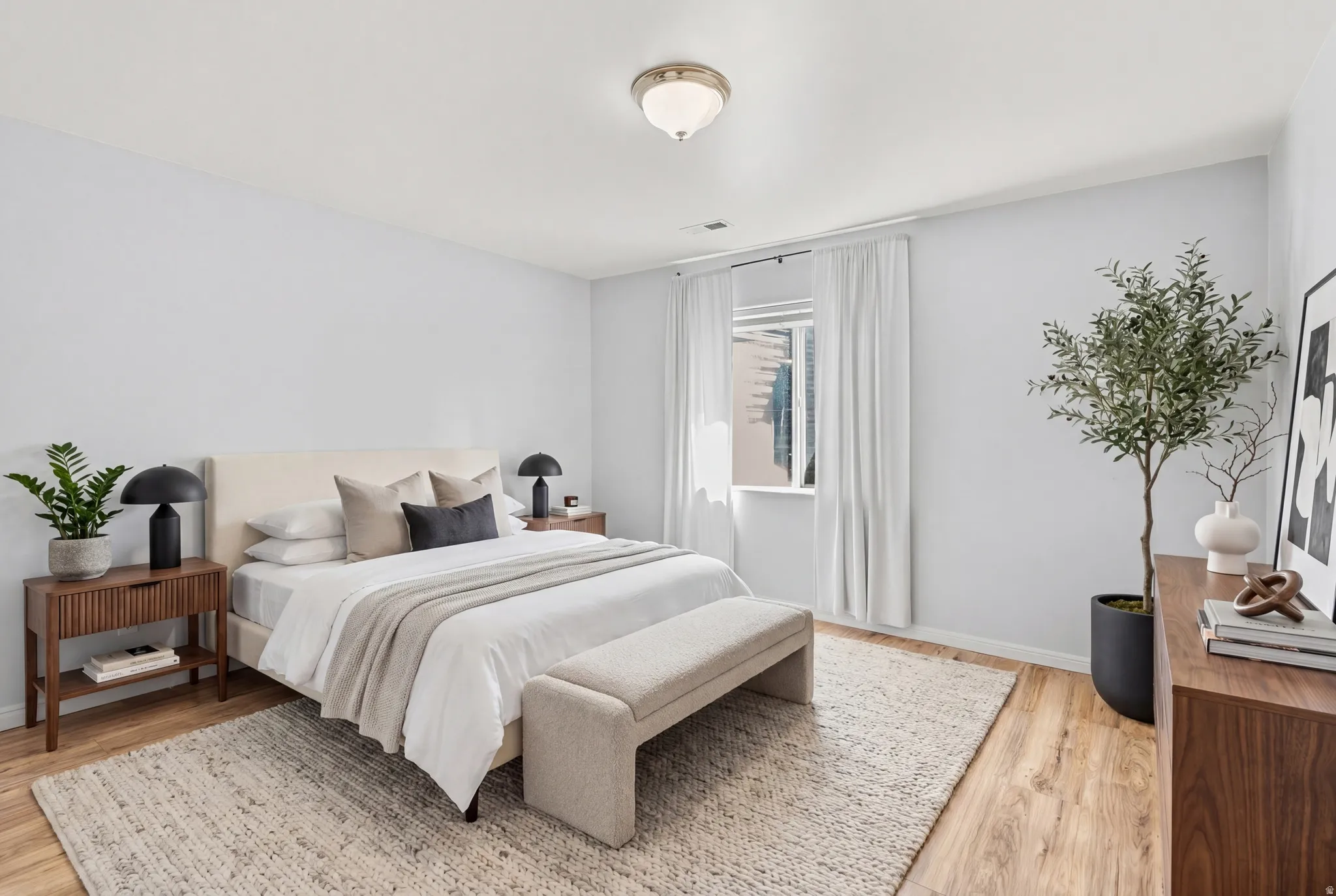 Light wood-finish flooring complements the neutral wall color