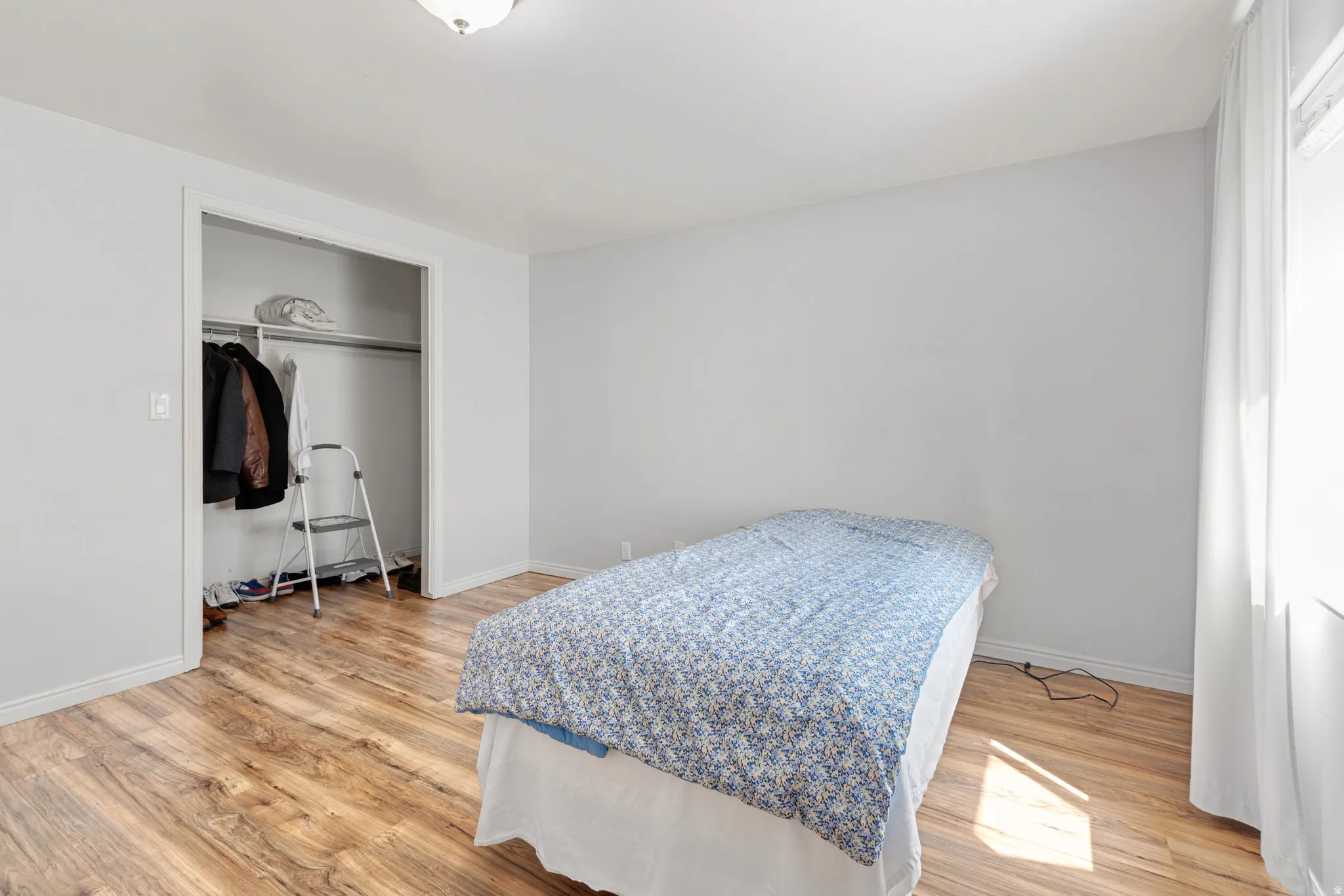 Neutral wall tones with wood-finish flooring