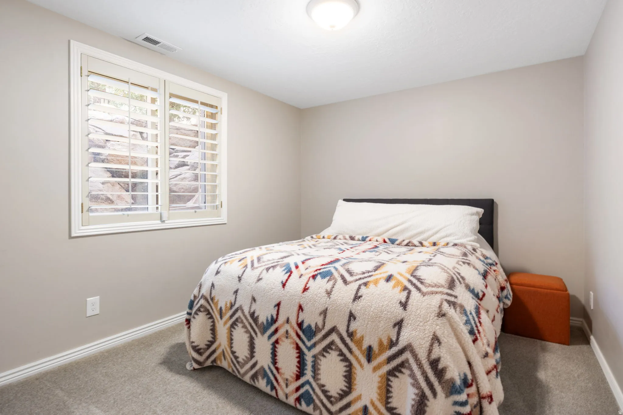 Recessed window featuring white plantation shutters