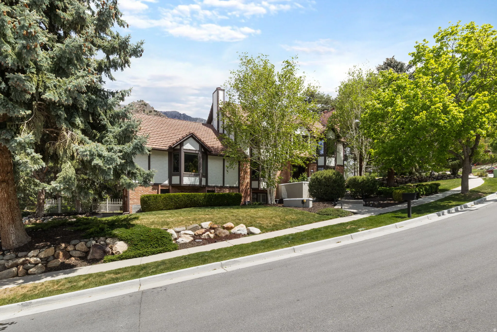 Traditional-style residence featuring a prominent bay window and an integrated chimney