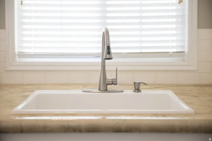 White single-basin sink with a gooseneck faucet