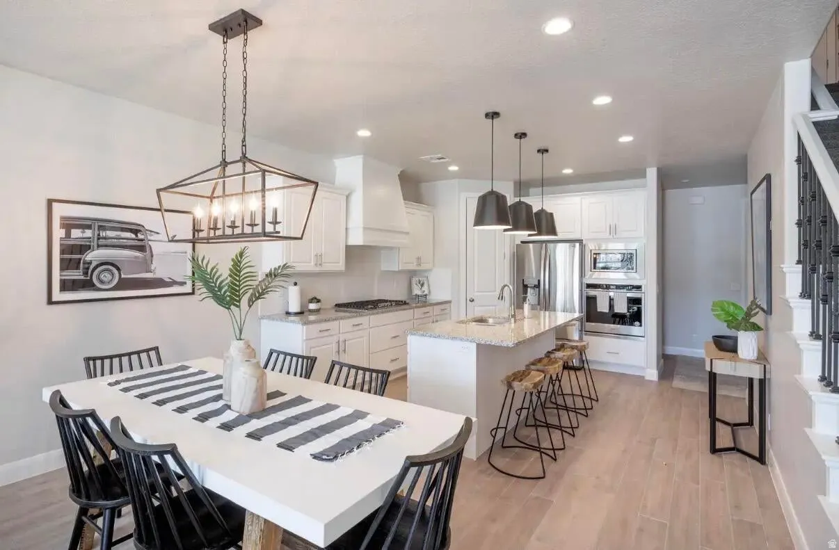 Open concept kitchen and dining area with wood-finish flooring