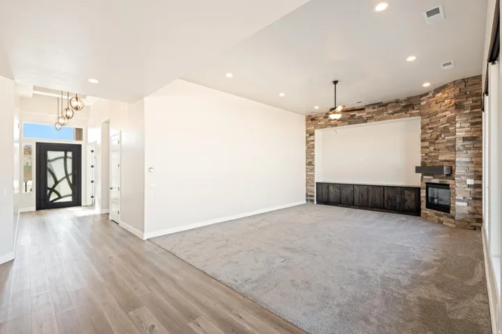 Spacious interior featuring a stone accent wall with an integrated fireplace and dark wood-finish cabinetry