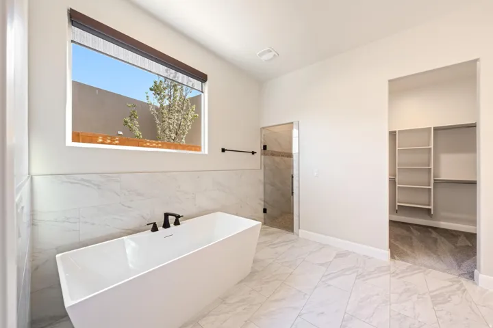 Modern bathroom featuring a freestanding tub with matte black fixtures