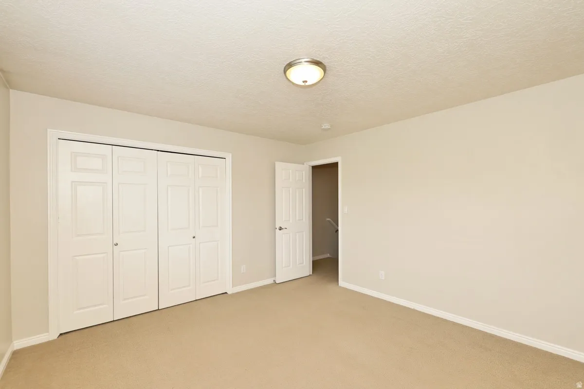 Neutral tone wall paint with white baseboards and trim