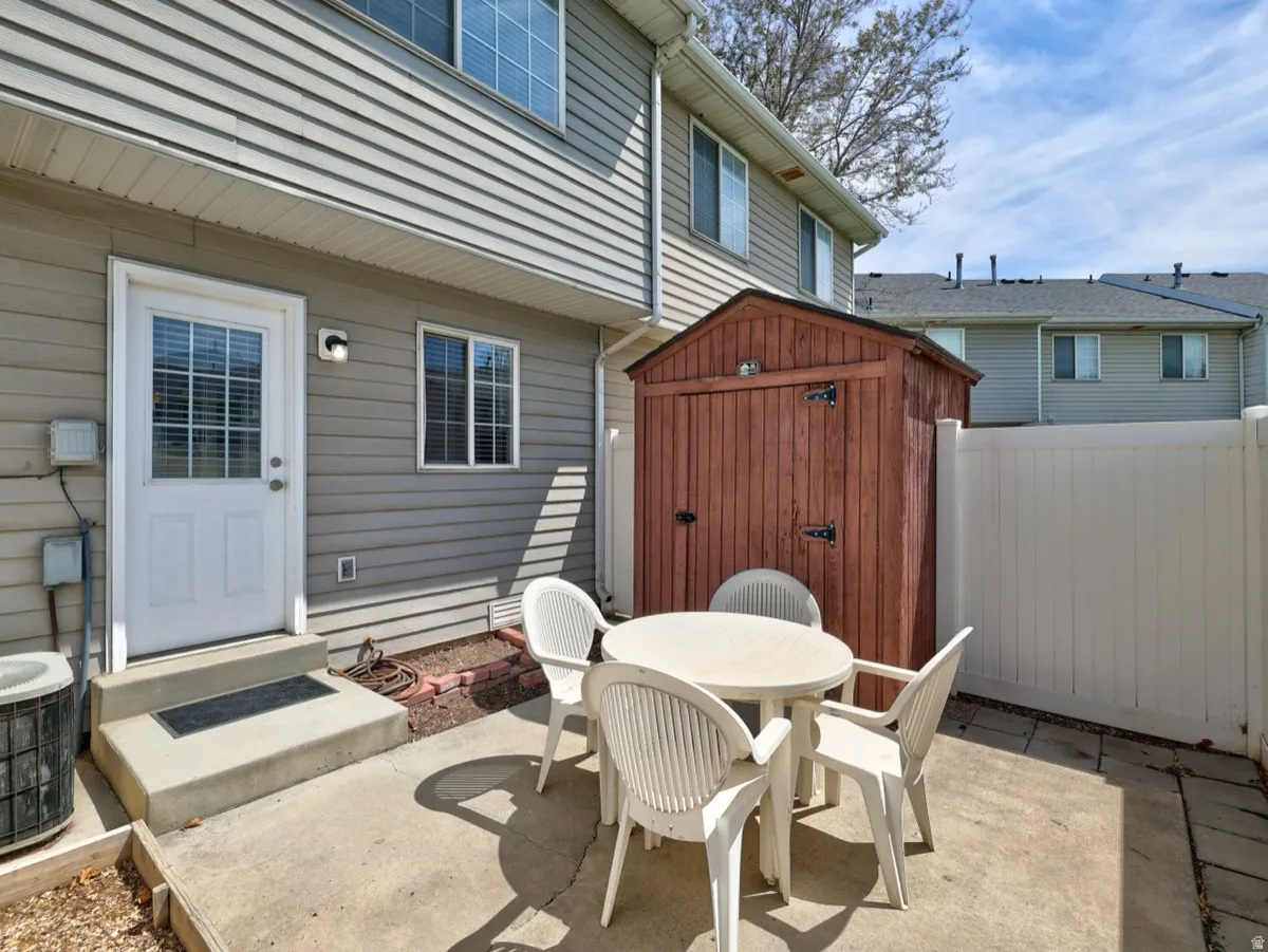 Private patio space featuring concrete paving and a privacy fence