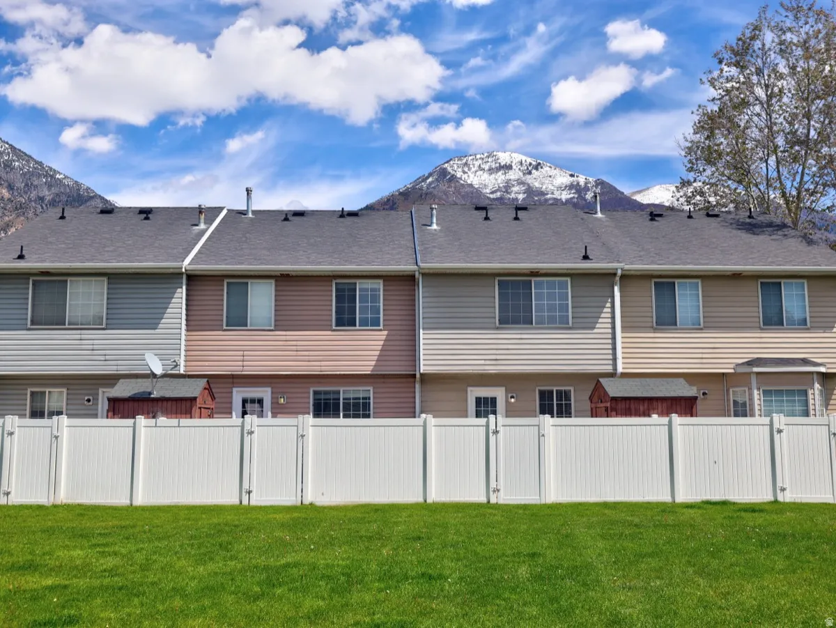 Expansive green lawn bordering a white vinyl privacy fence