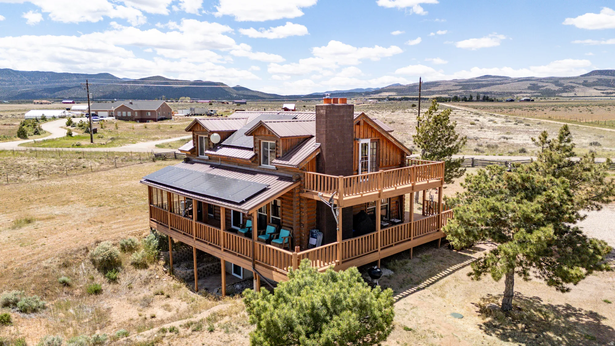 Log cabin exterior featuring multiple balconies and solar panels