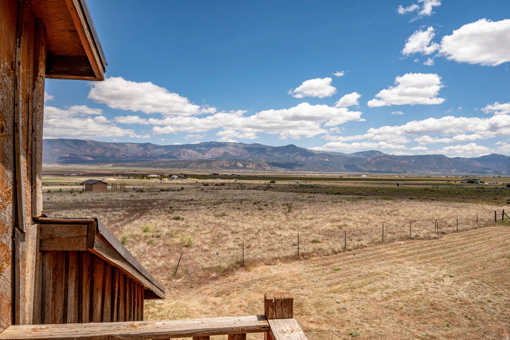 Expansive natural landscape featuring distant mountain ranges under a clear sky