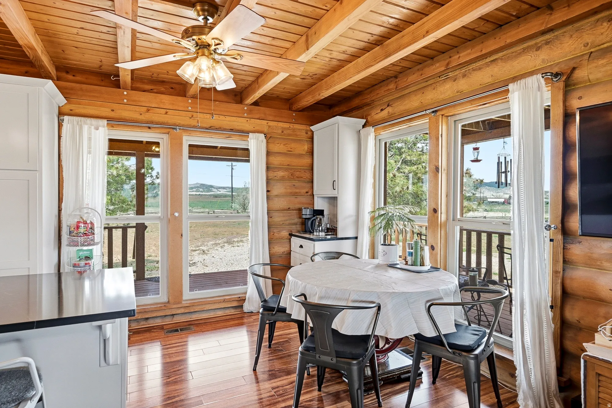 Interior space with exposed wood beam ceiling and log walls