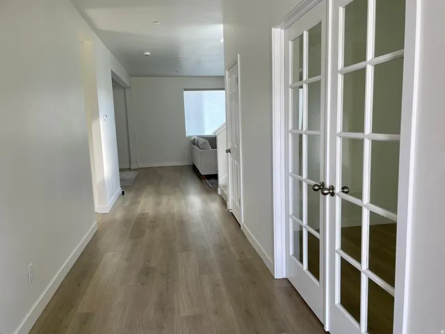 Bright interior hallway with wood-finish flooring