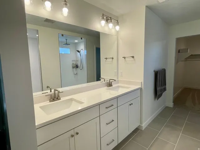 Dual vanity with white cabinetry and integrated sinks