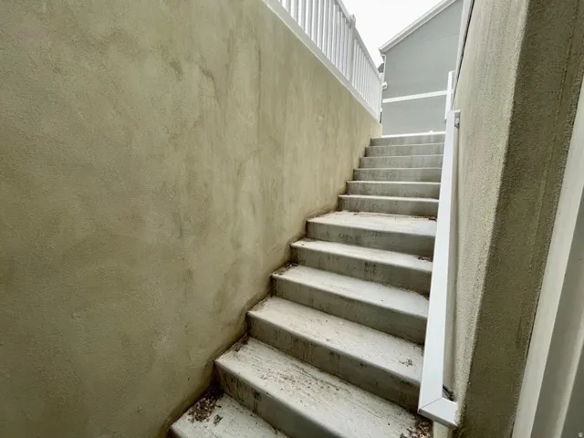 Concrete staircase with white railing