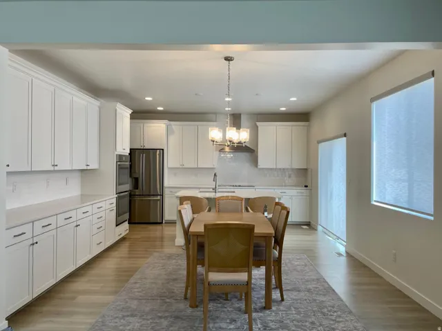Open-concept living space with light wood-finish flooring