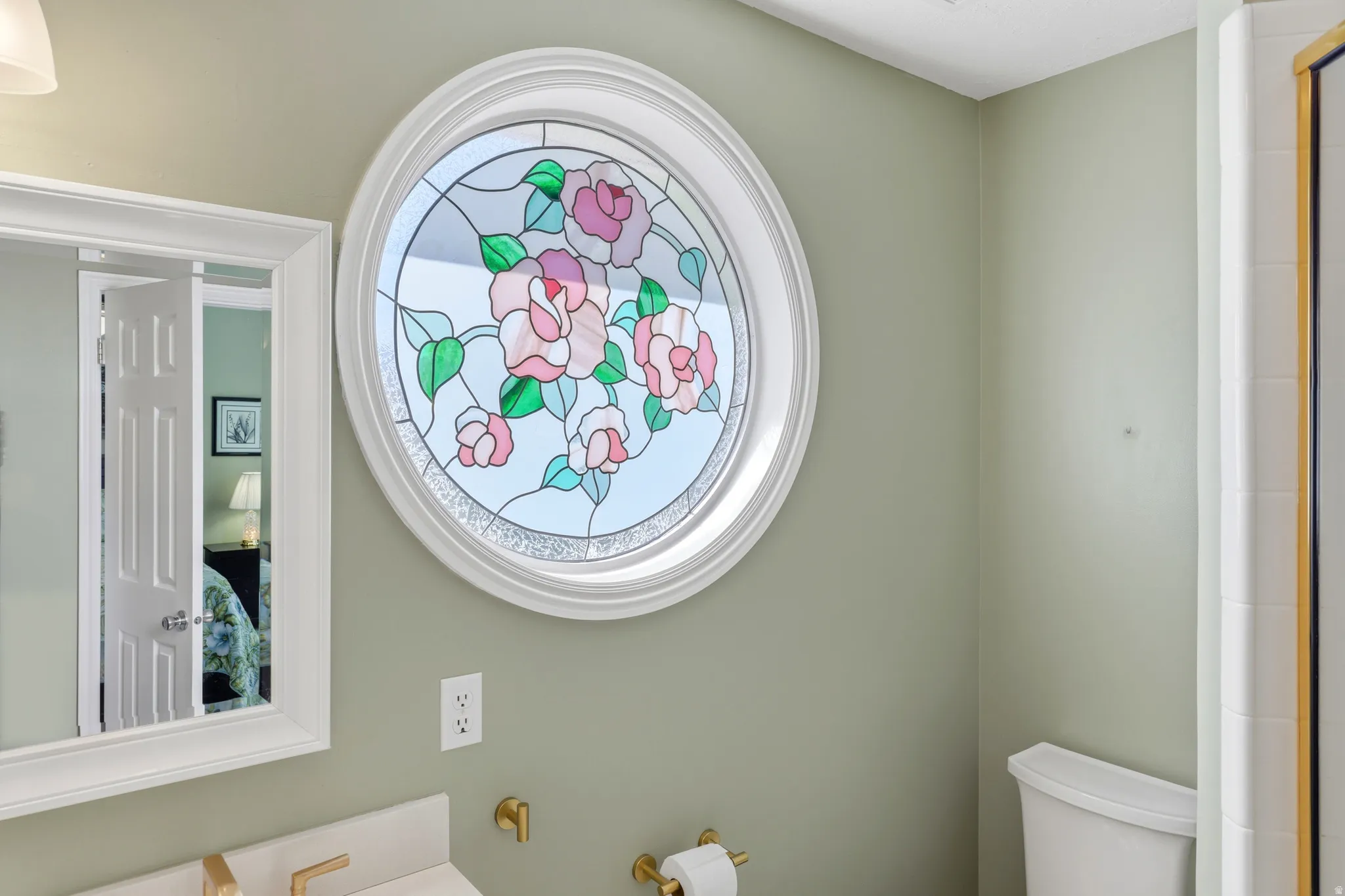 Circular stained-glass window featuring a floral design