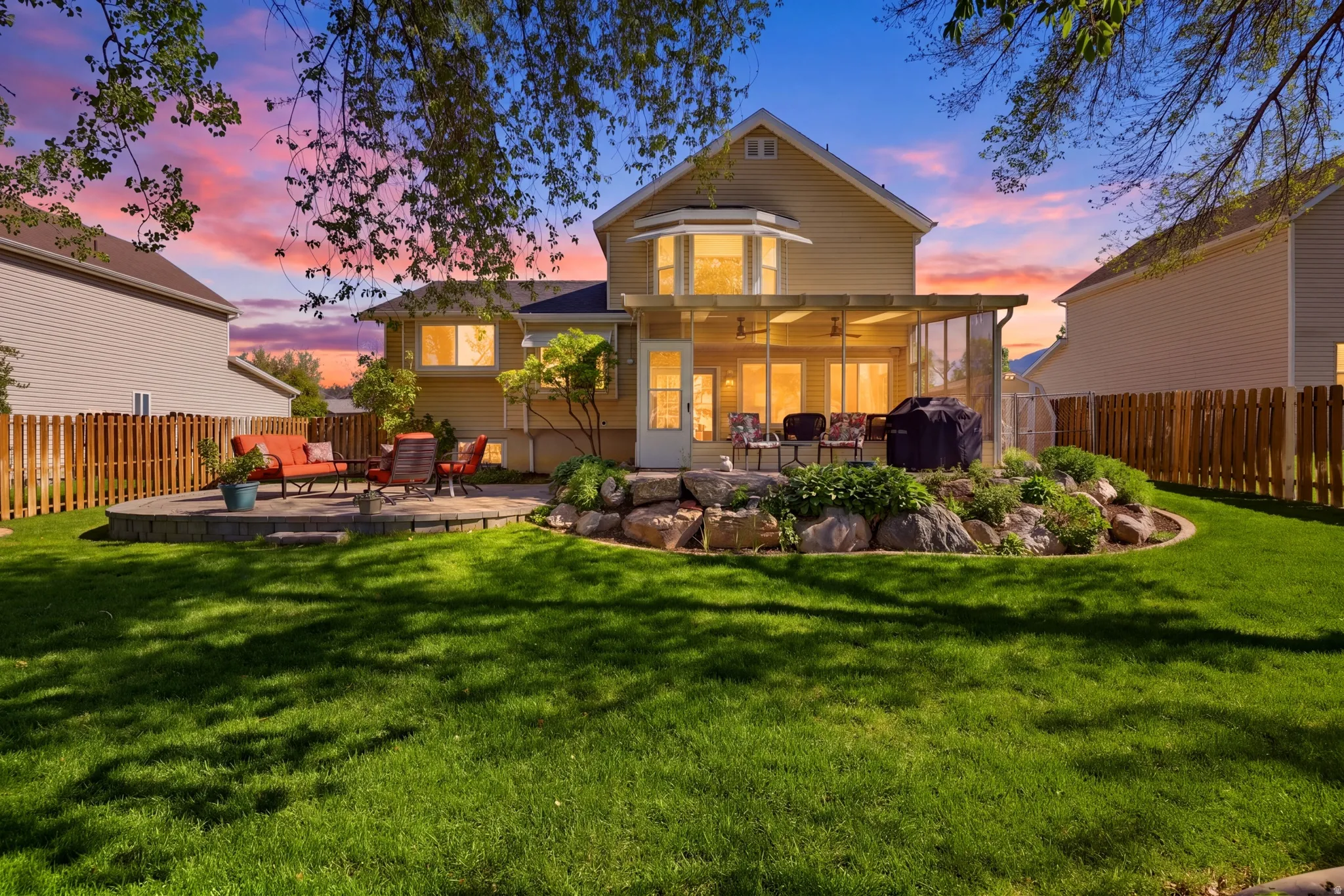 Spacious rear yard featuring a manicured lawn and privacy fencing