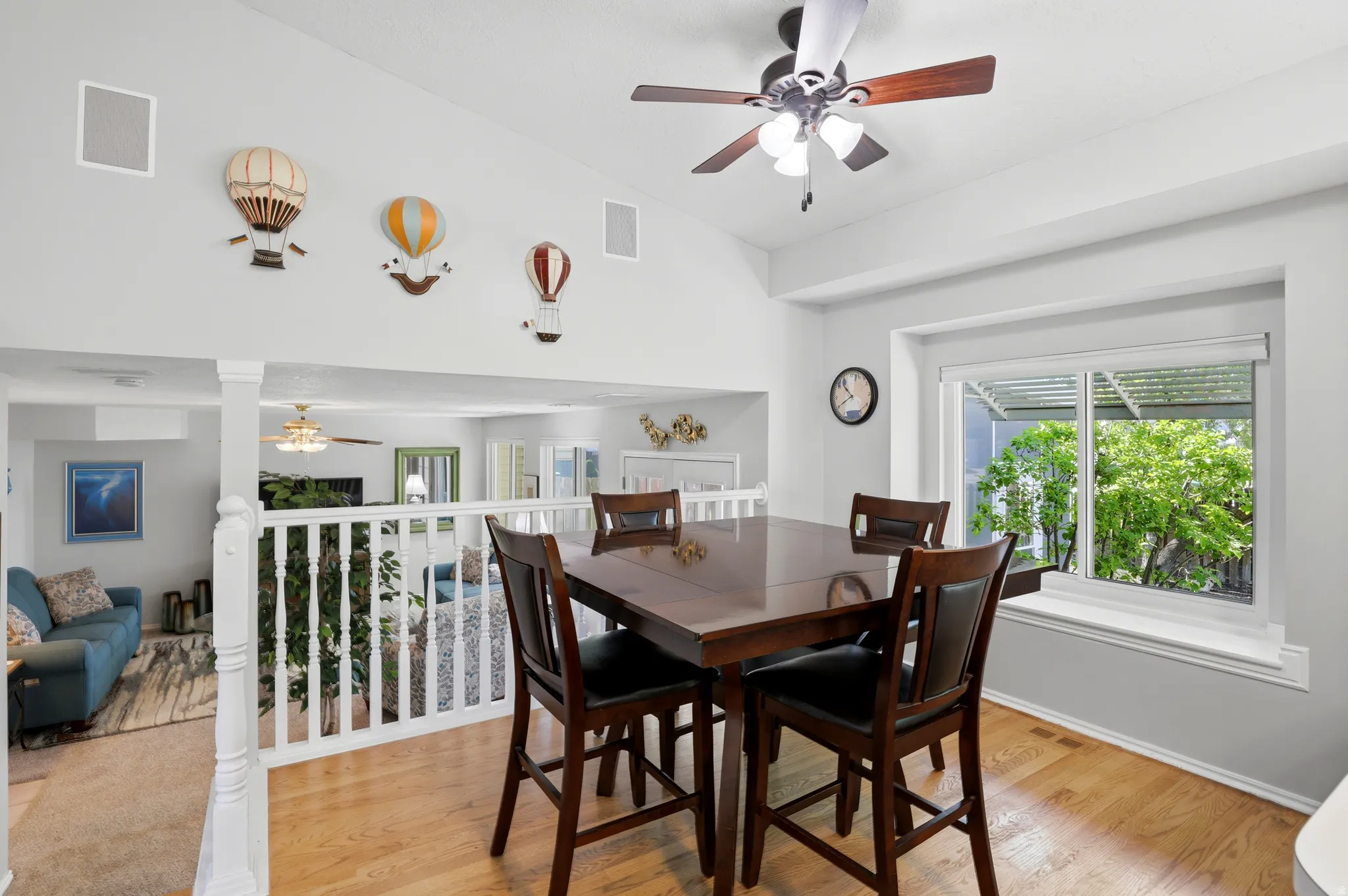 High ceilings featuring integrated audio speakers and a ceiling fan with light fixture
