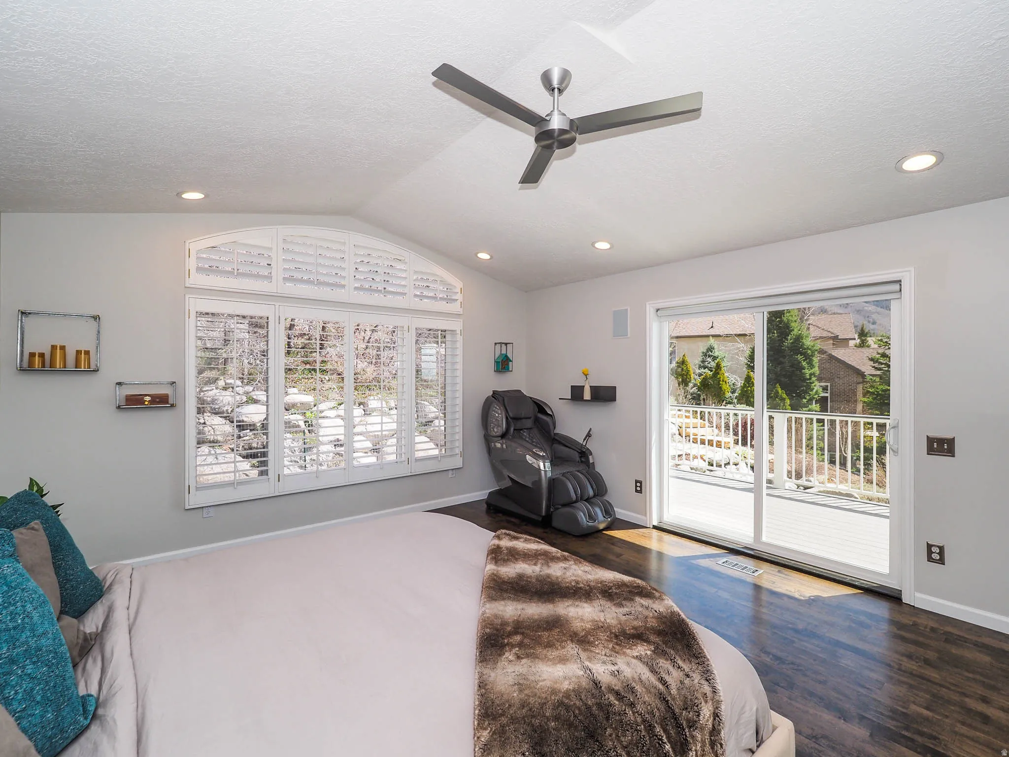 Large, Private Primary En Suite with Expansive Vaulted Ceiling, Modern Newer Ceiling Fan, Wonderful Newer Patio Door with Newer Remote Controlled Electronic Shade Offering a Seamless Connection to Romantic Outdoor Spaces from Your Beautiful Newer Deck!