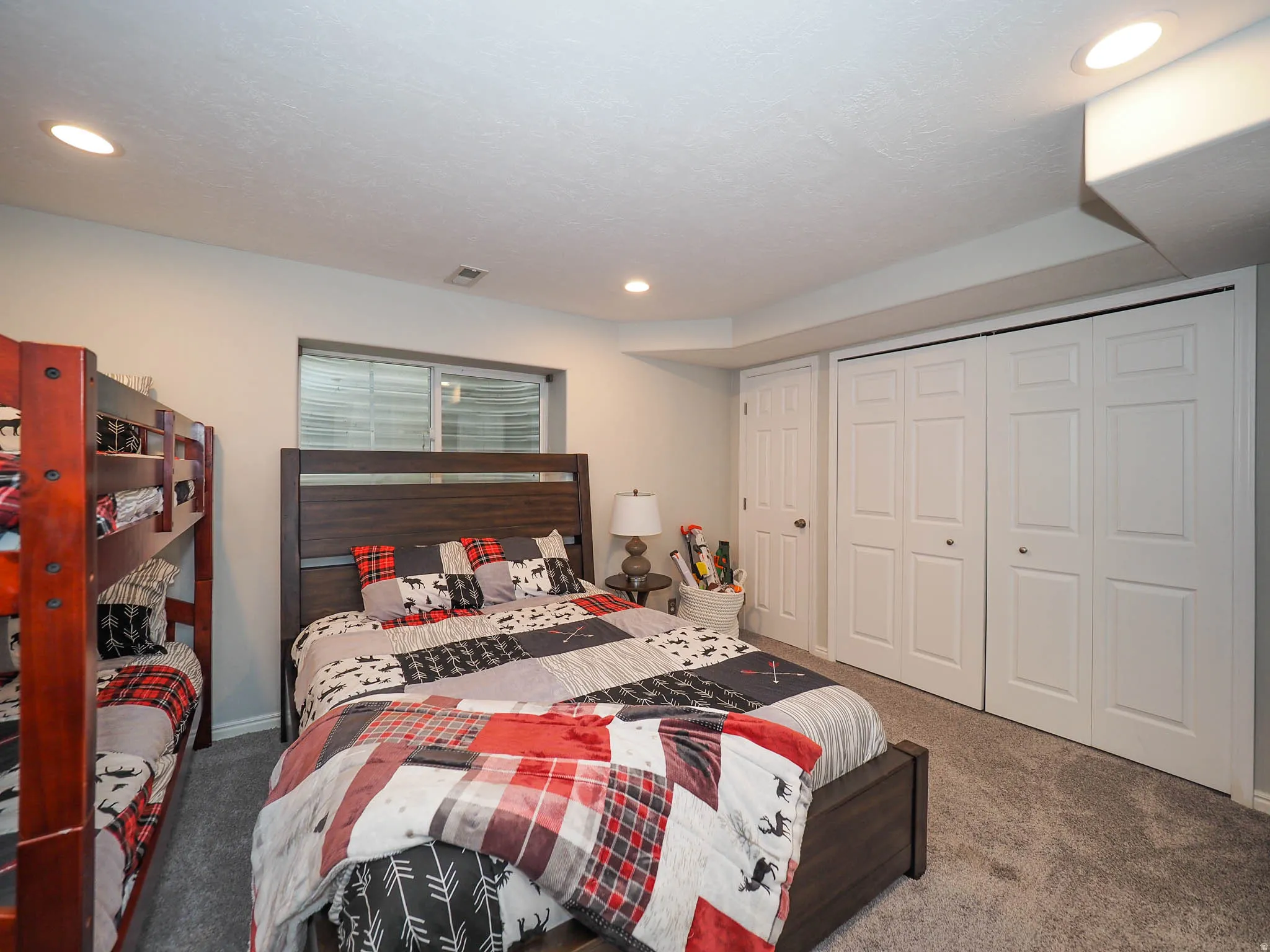Spacious 5th Bedroom with Recessed Lighting Featuring Plush Carpet Flooring, a Window with Blinds, and Soft Relaxing Wall Tones.