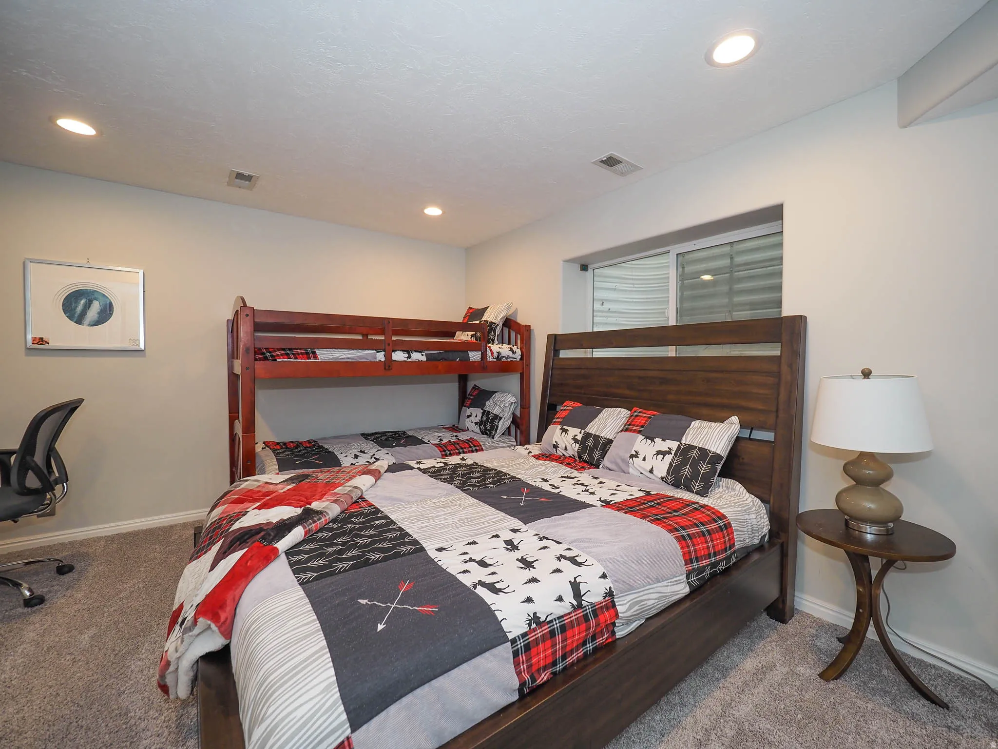 Spacious 5th Bedroom with Recessed Lighting Featuring Plush Carpet Flooring, a Window with Blinds, and Soft Relaxing Wall Tones.