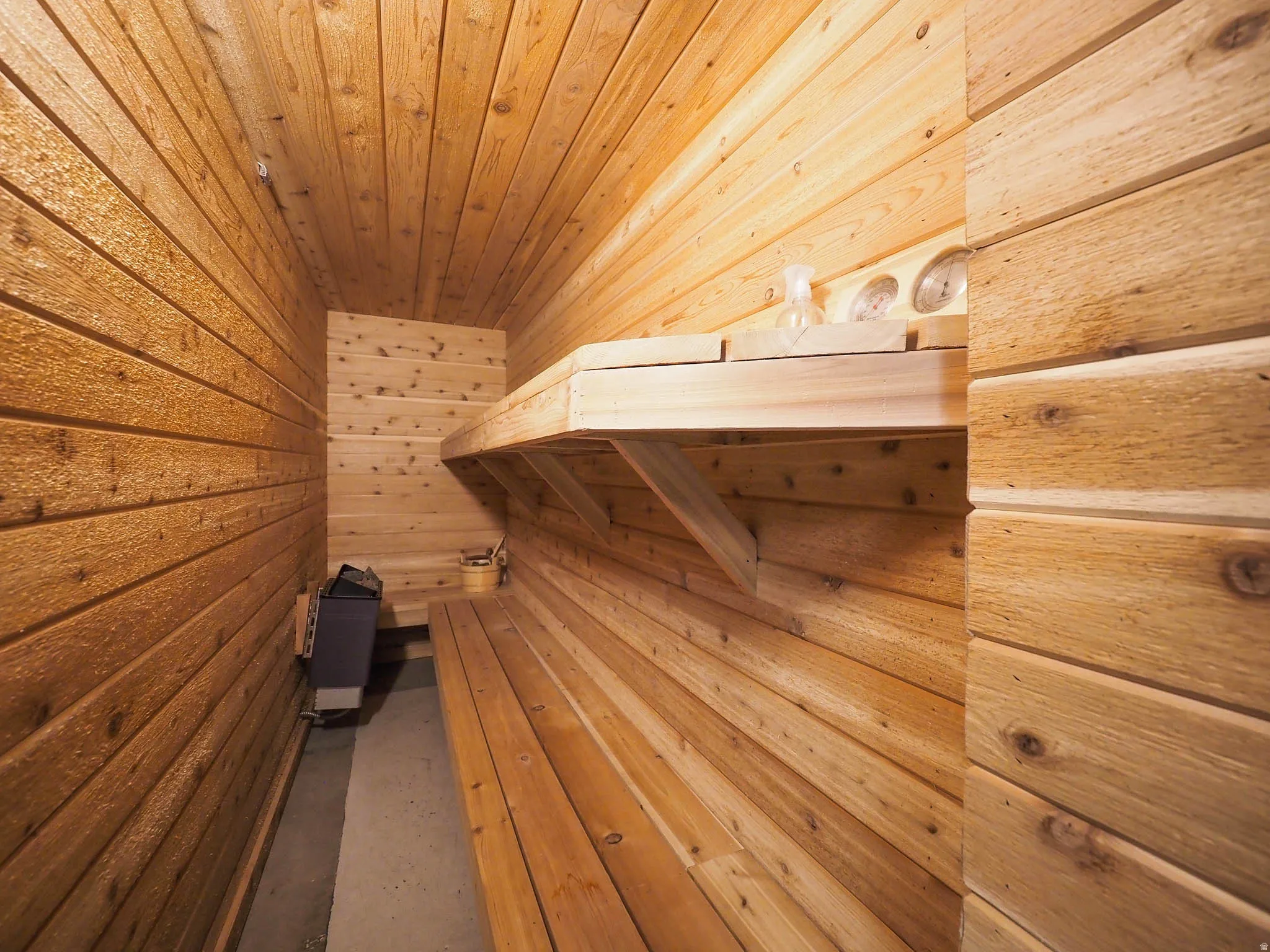 Lounge in Your Awesome Private Sauna Featuring Built-In Wooden Benches, Heating Unit & More!