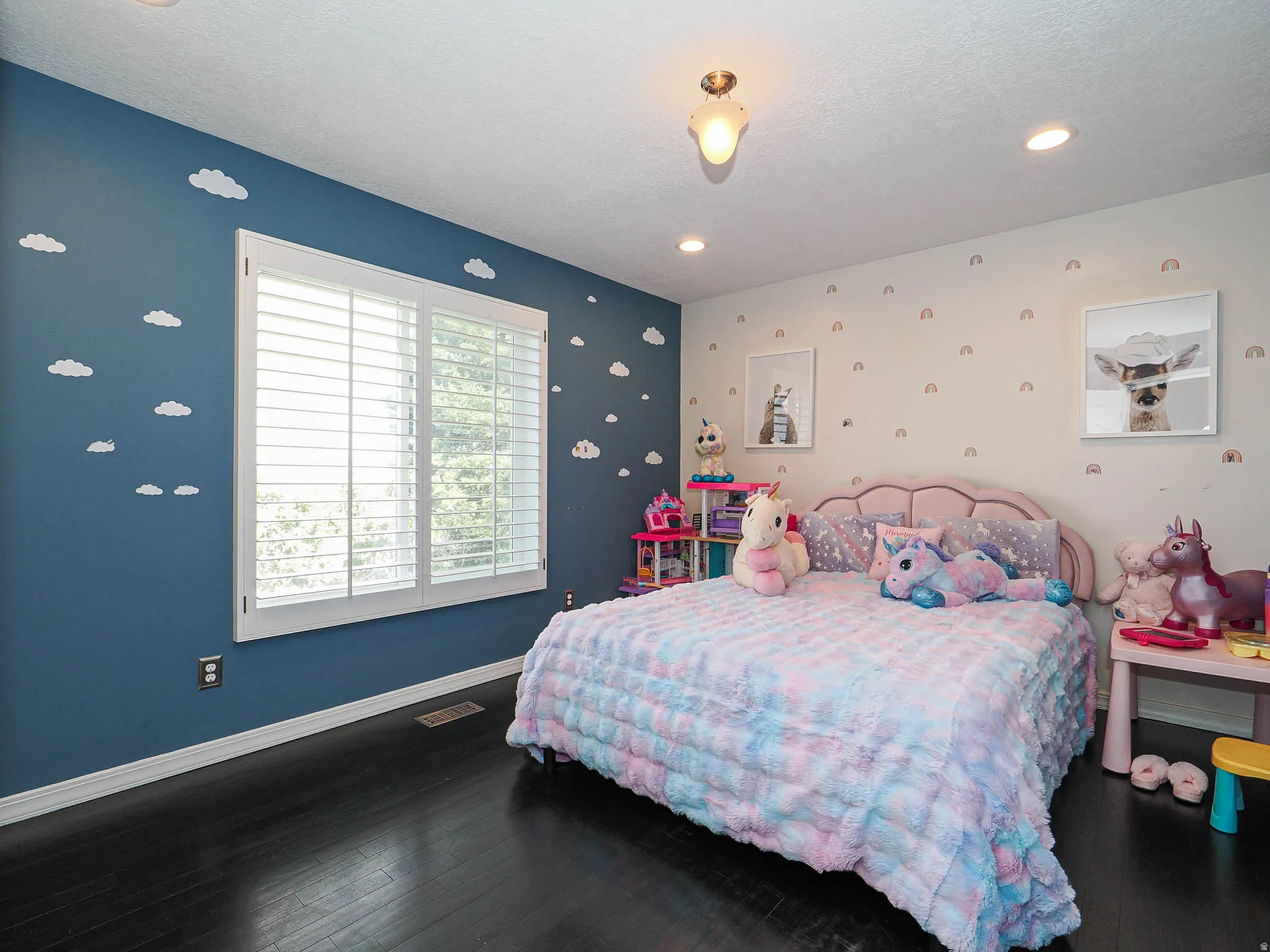 Spacious 3rd Bedroom  Featuring Beautiful Wood-Finish Flooring and a Large Window with White Plantation Shutters